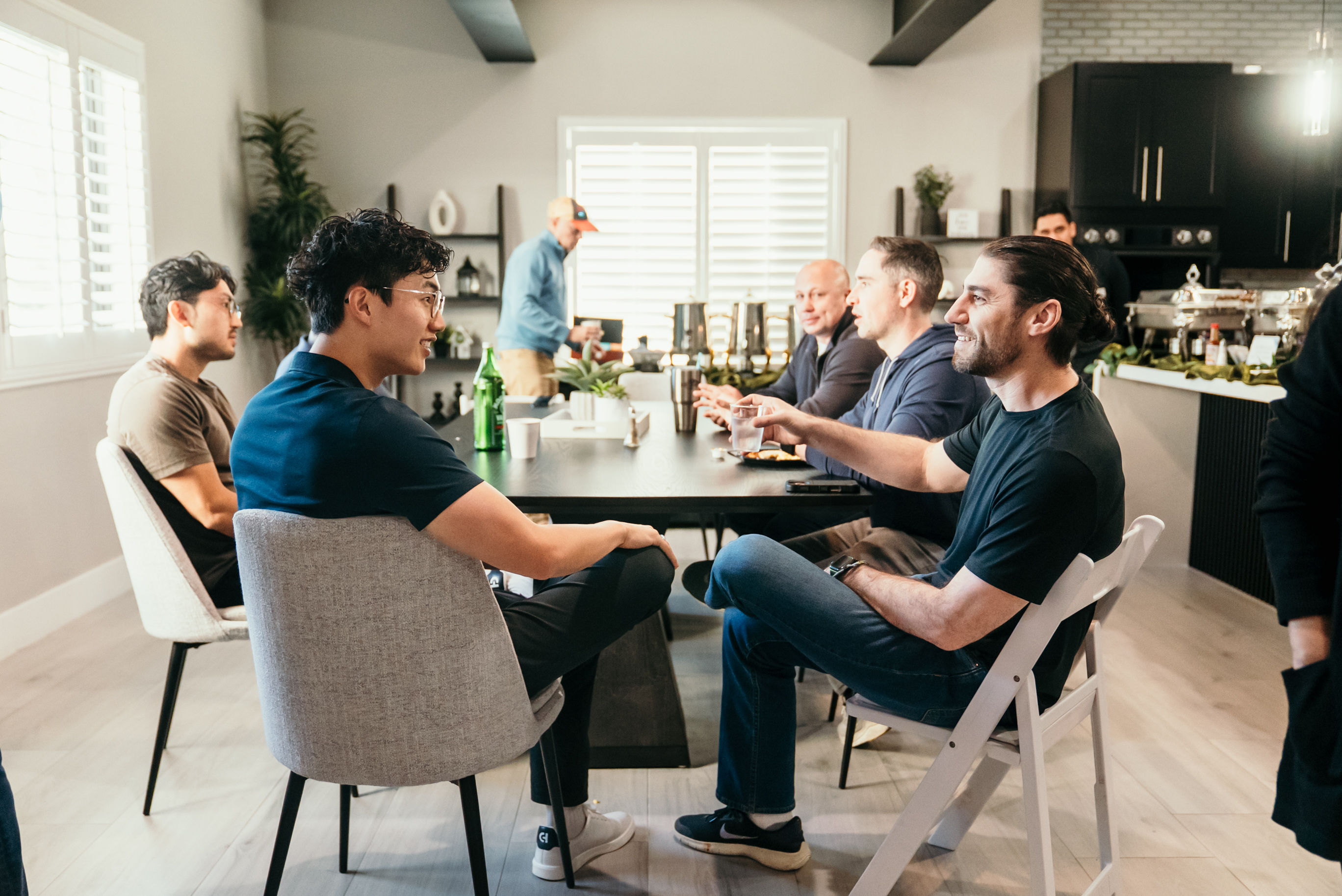 Two operators talking through a deal at the kitchen table.